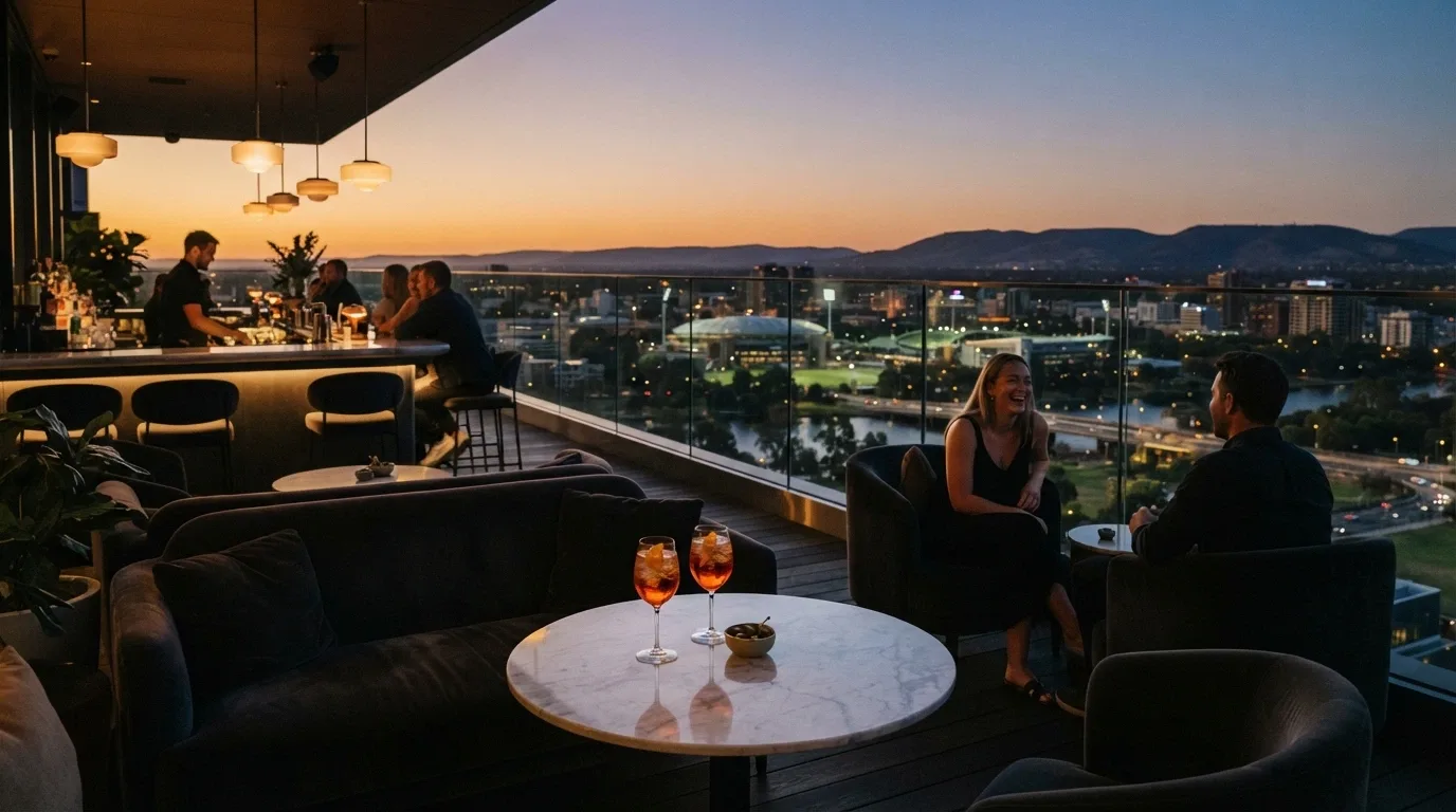 The SOL Rooftop bar on level nine at dusk, with city skyline views, low lounge seating, and cocktail glasses on a marble table